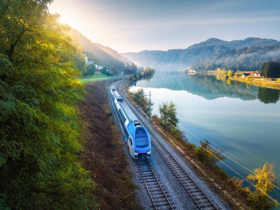 Aerial,View,Of,Blue,Modern,High,Speed,Train,Moving,Near