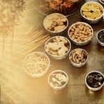Modern Ayurveda practice with herbs, tablets, and stethoscope on wooden table