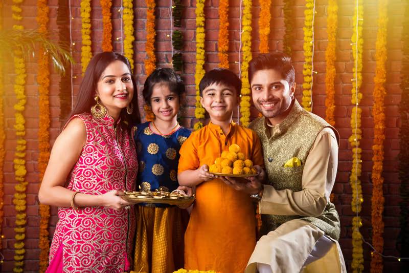 People exchanging Diwali gifts and traditional sweets like laddoos and barfi