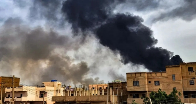 Dense smoke plume over Gaza neighborhood following an explosion