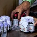 Doctors examine patients affected by toxic cough syrup in a government hospital