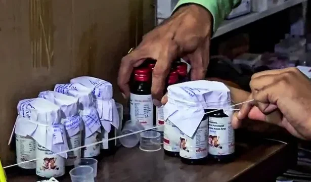 Doctors examine patients affected by toxic cough syrup in a government hospital