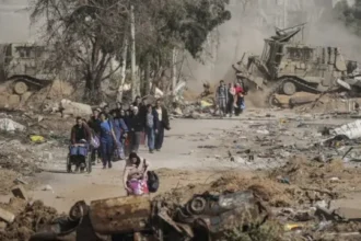 Palestinian residents inspect the ruins of homes destroyed in overnight Israeli air raids