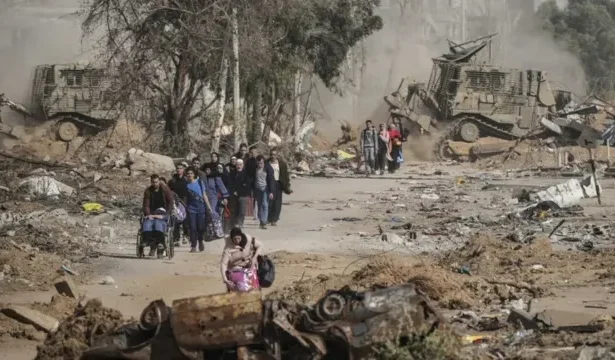 Palestinian residents inspect the ruins of homes destroyed in overnight Israeli air raids