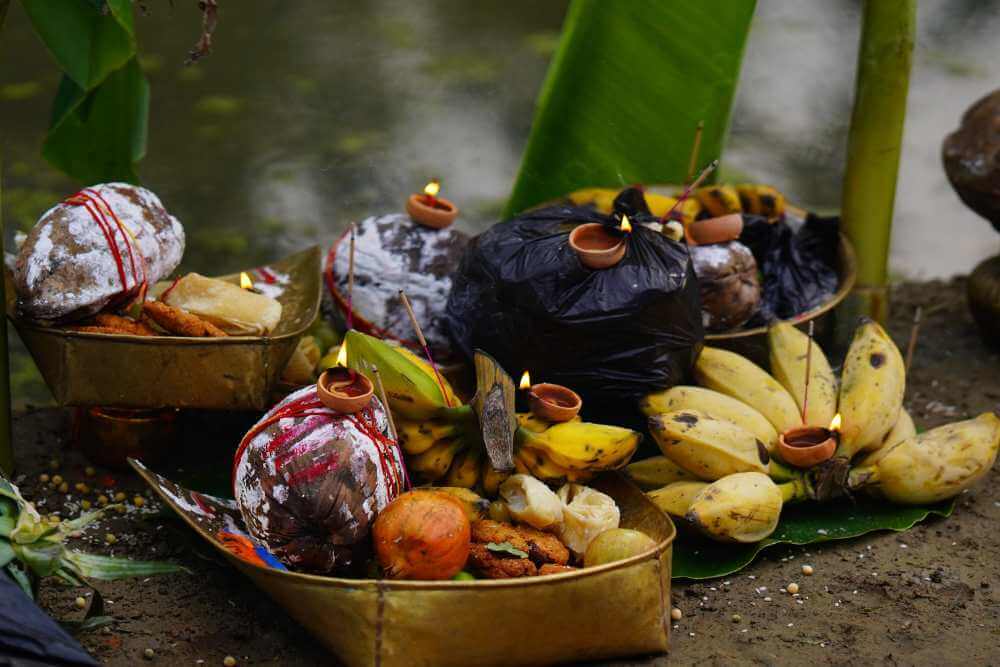 Sacred Chhath Puja offerings of fruits, thekua, and sugarcane