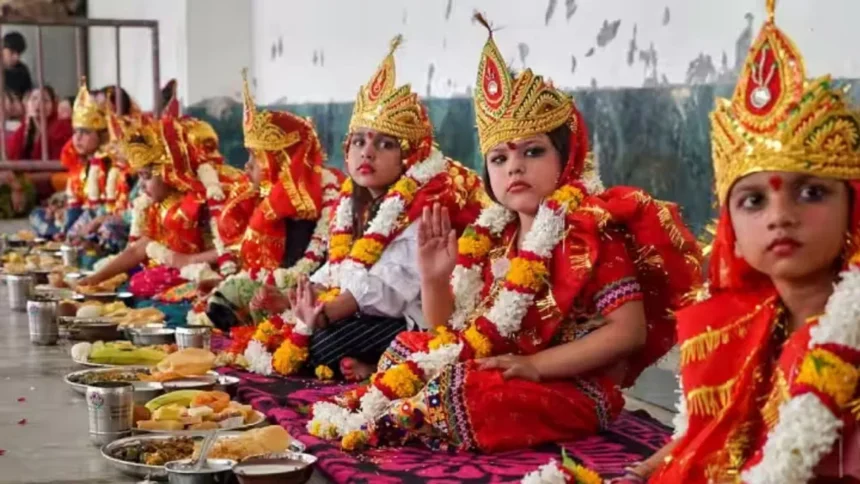 Women performing Pushpanjali and Kanya Puja rituals on Durga Ashtami 2025 in India