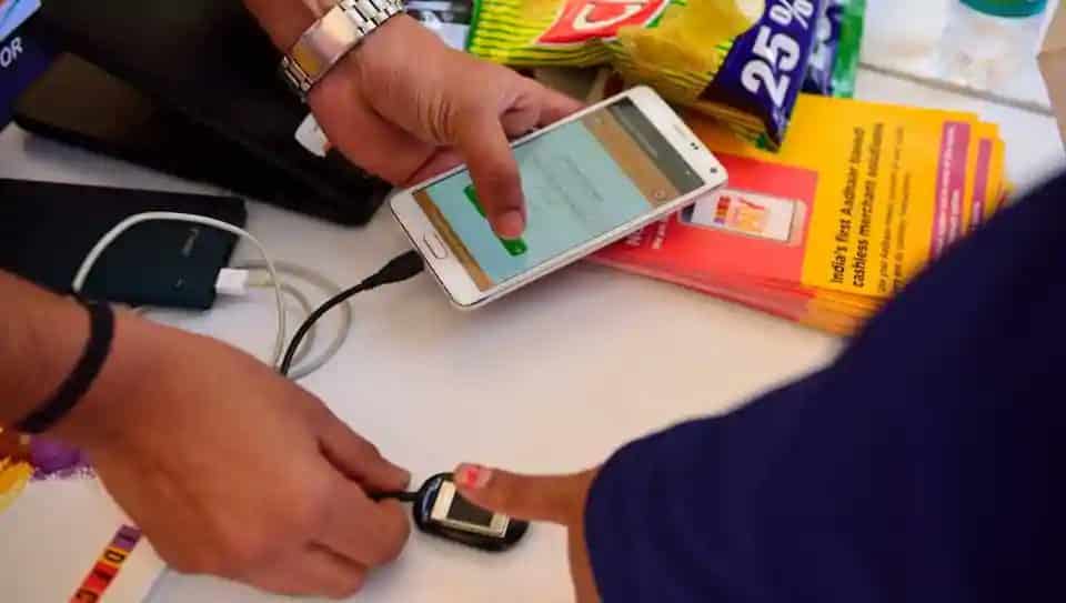 User verifying UPI transaction using Aadhaar-linked fingerprint scanner under India’s new biometric payment system