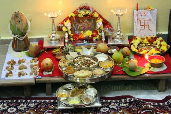 Hindu family performing Dhanteras 2025 pooja with diyas, Lakshmi idol, and gold coins