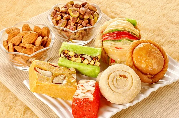 Indian family celebrating Diwali together with sweets, diyas, and laughter