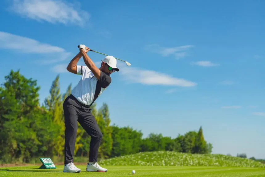 Golfer swinging on a lush green golf course symbolizing fitness and focus