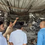 Police and forensic teams inspecting the burnt interiors of the nightclub in Goa