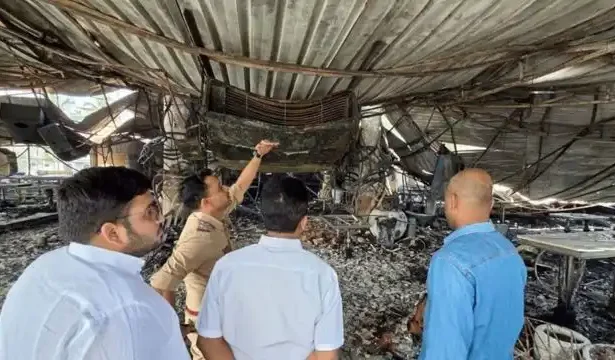 Police and forensic teams inspecting the burnt interiors of the nightclub in Goa