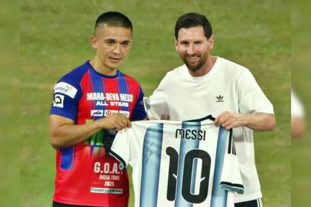 Indian football fans cheering inside a packed stadium