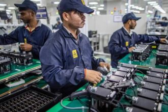 Indian workers assembling electronic components in a manufacturing unit