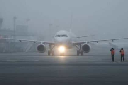 Dense winter fog reducing visibility at an Indian airport runway, causing flight delays