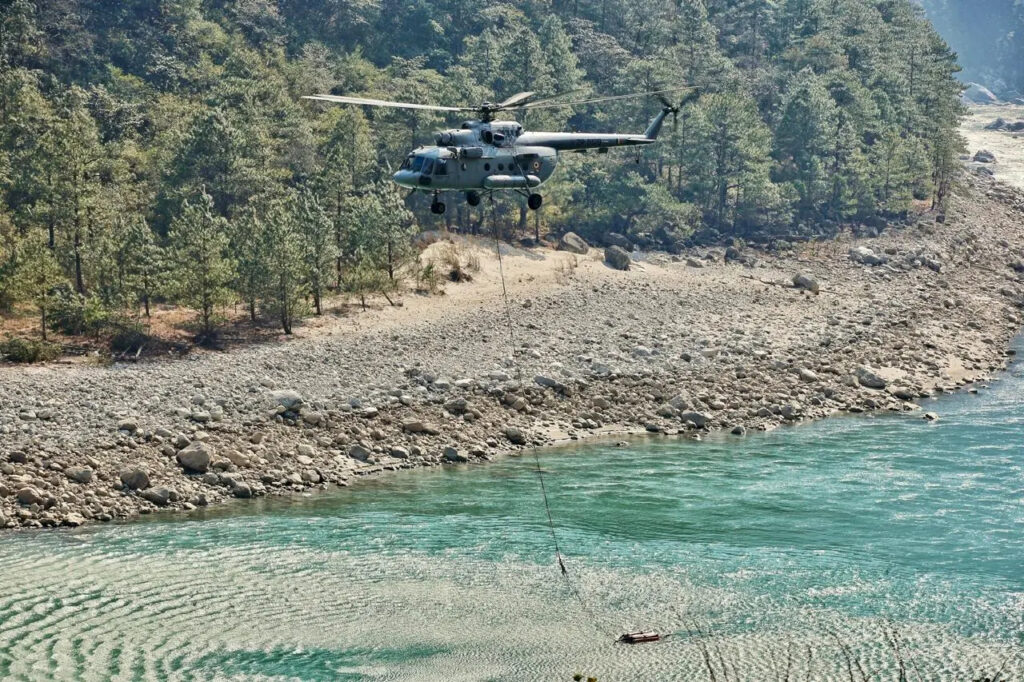 Indian Air Force helicopter conducting firefighting operations during forest fire in Arunachal Pradesh