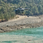 Indian Air Force helicopter conducting firefighting operations during forest fire in Arunachal Pradesh