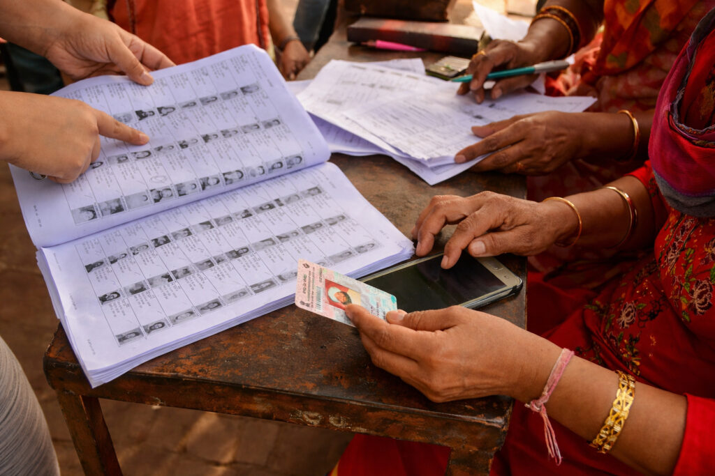 Indian voters standing in queue for voter list verification during SIR process
