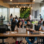 Startup India scheme impact showing entrepreneurs working in modern Indian startup office