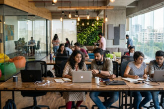 Startup India scheme impact showing entrepreneurs working in modern Indian startup office