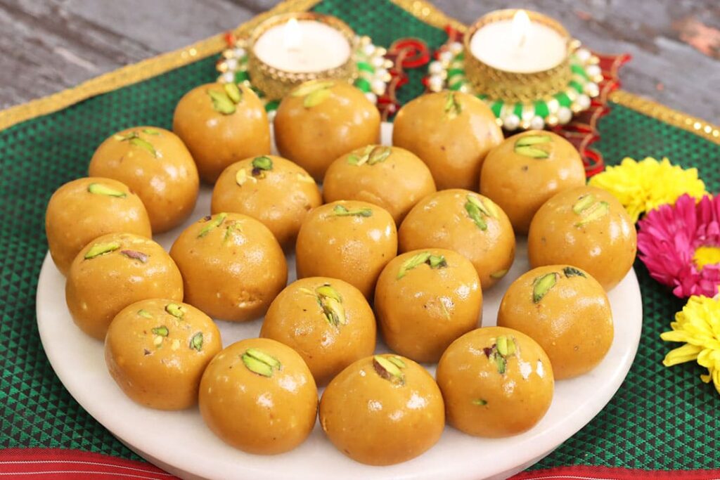 Golden besan laddoos arranged on festive plate