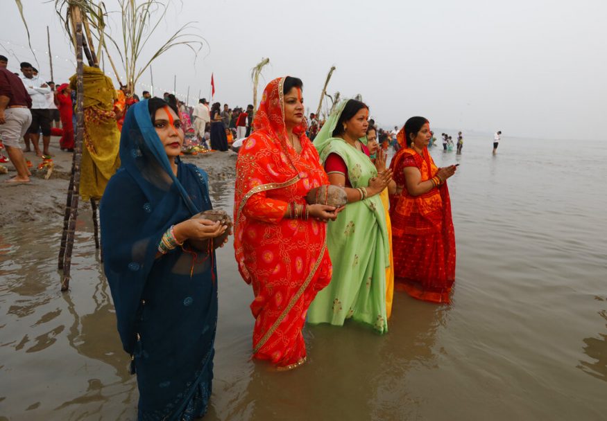 Golden sunrise as devotees offer arghya to Surya Dev during Chhath Puja.